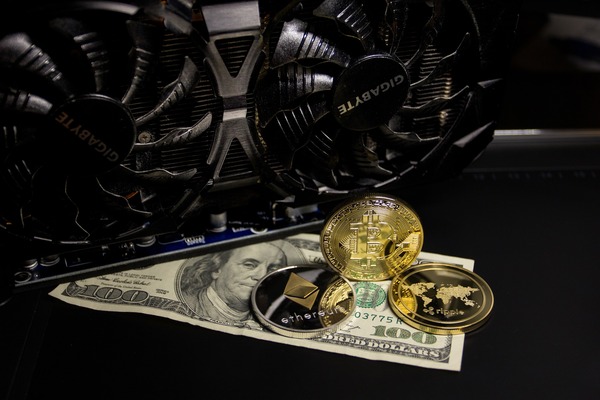 Gold coins and cryptocurrency trading background
